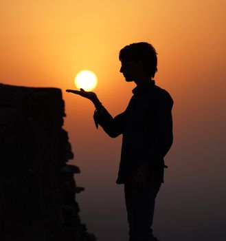 Captivating silhouette of a man during a vibrant sunset, outdoors.