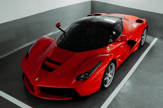 A stunning red Ferrari supercar parked indoors, showcasing luxury and performance.