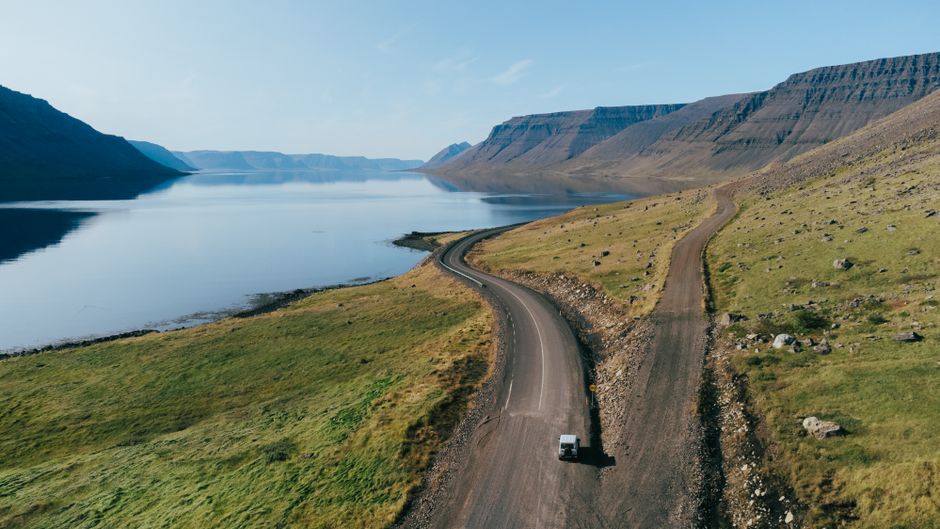 A stunning aerial view of a winding road by the fjords in Iceland's Westfjords region, perfect for travel enthusiasts.
