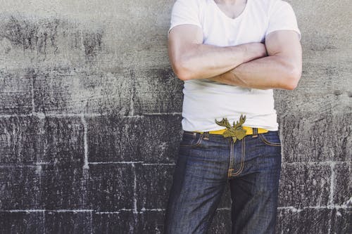 Man Leaning on Gray Wall