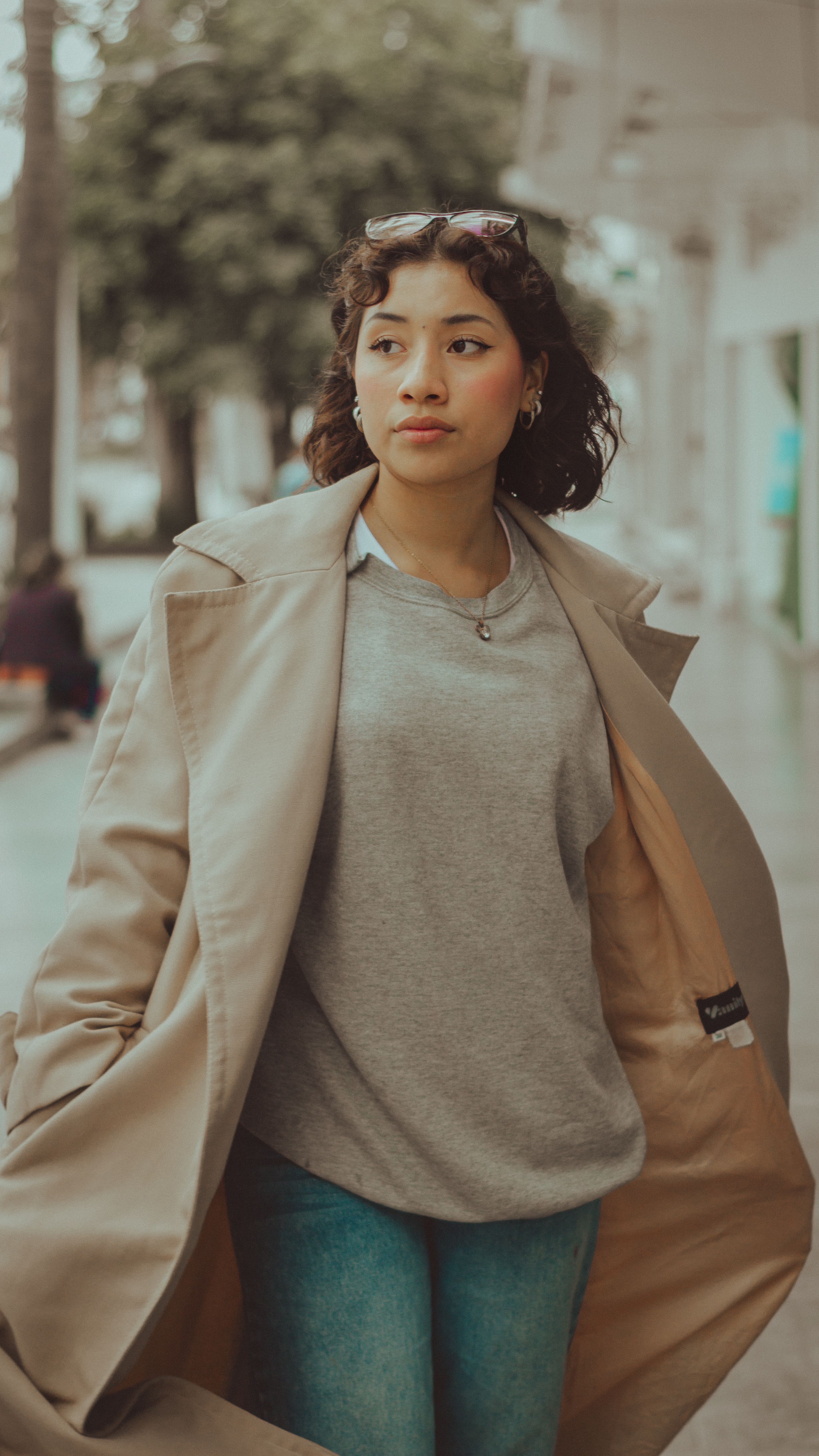 Young Woman in Stylish Coat Walking on City Street · Free Stock Photo