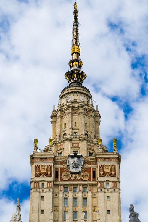 Free Majestic Moscow tower with intricate architecture set against a vibrant blue sky. Stock Photo