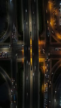 Stunning aerial view of a busy city highway intersection illuminated by street lights.