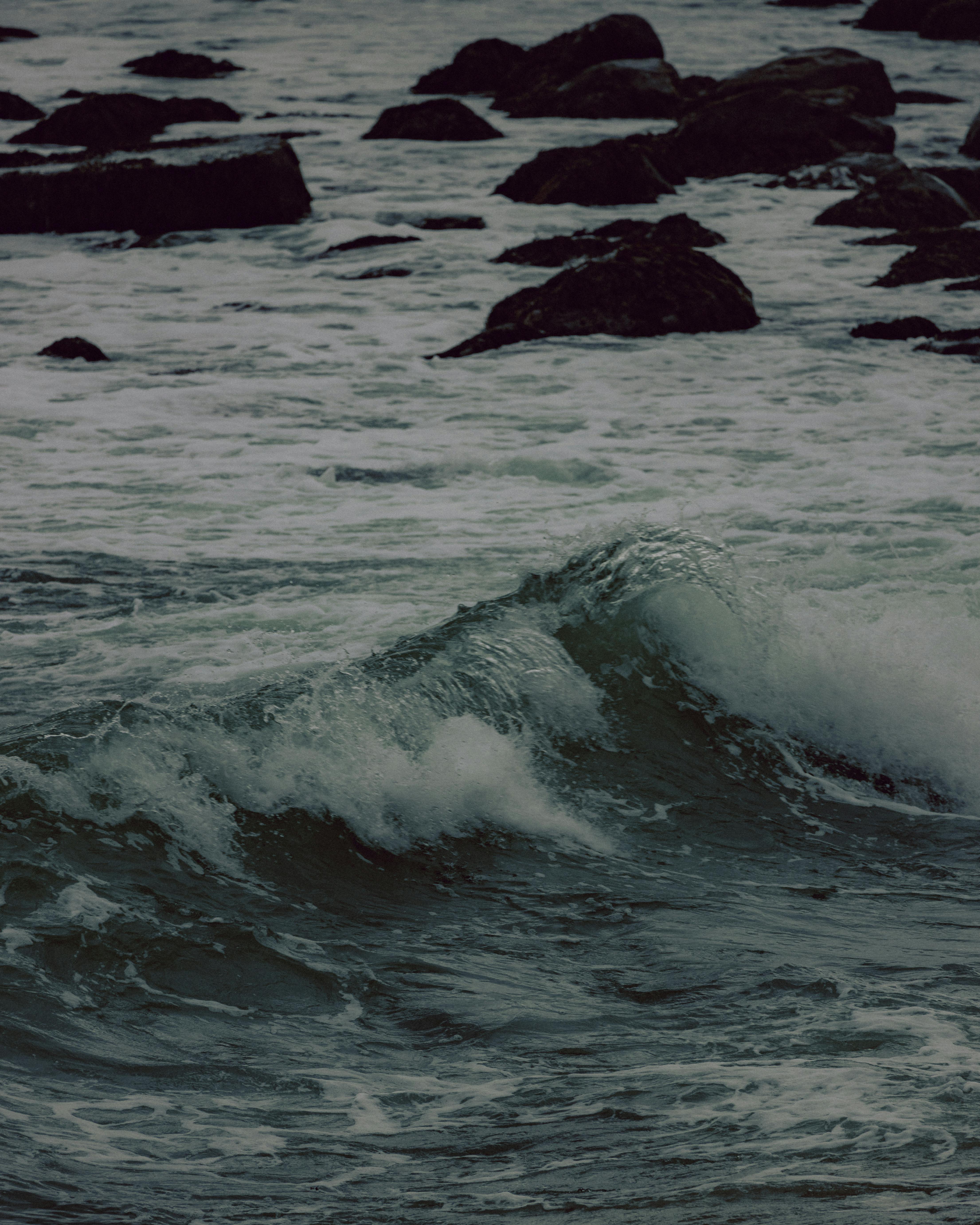 dramatic ocean waves crashing on rocky shoreline