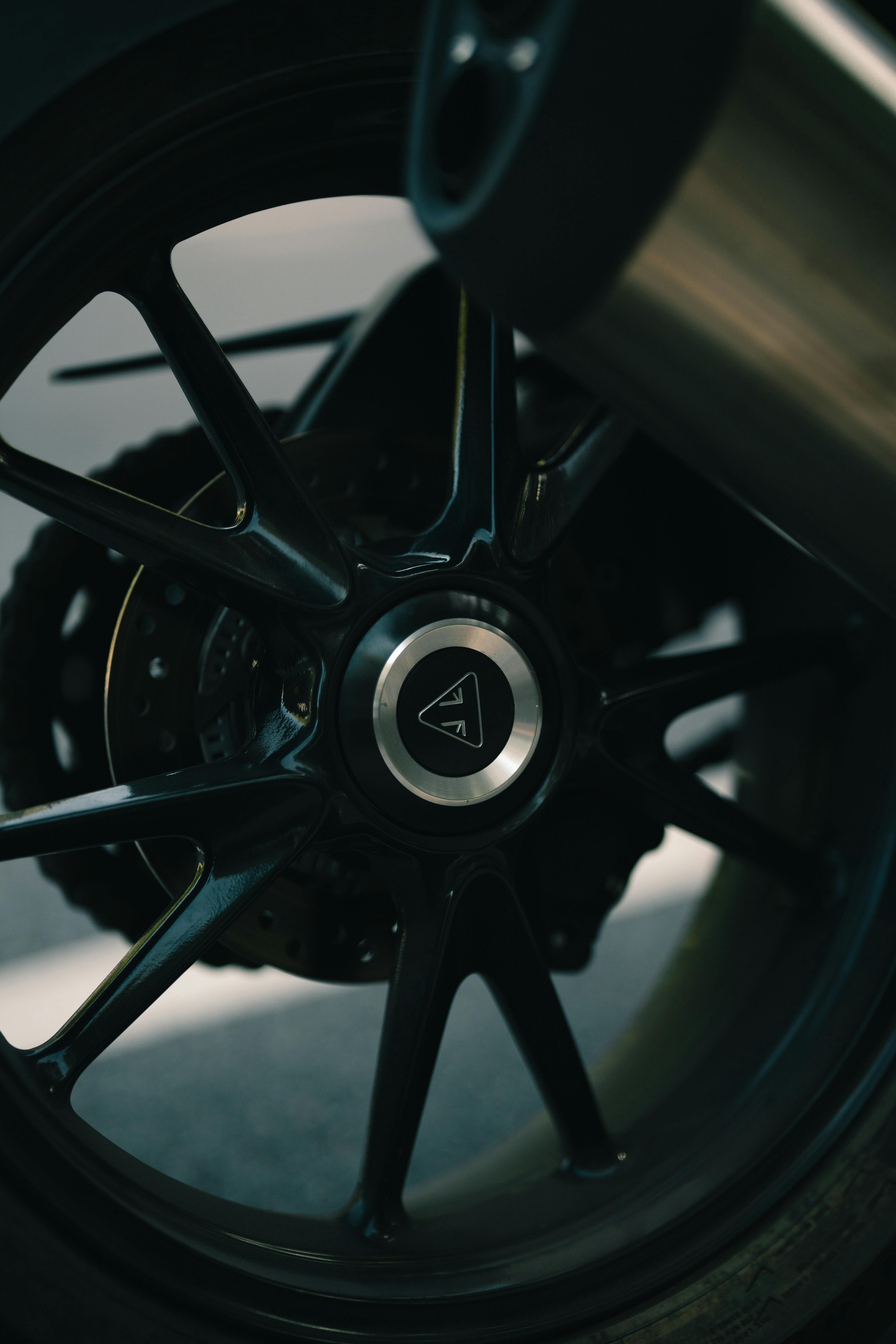 close up of black car wheel and exhaust