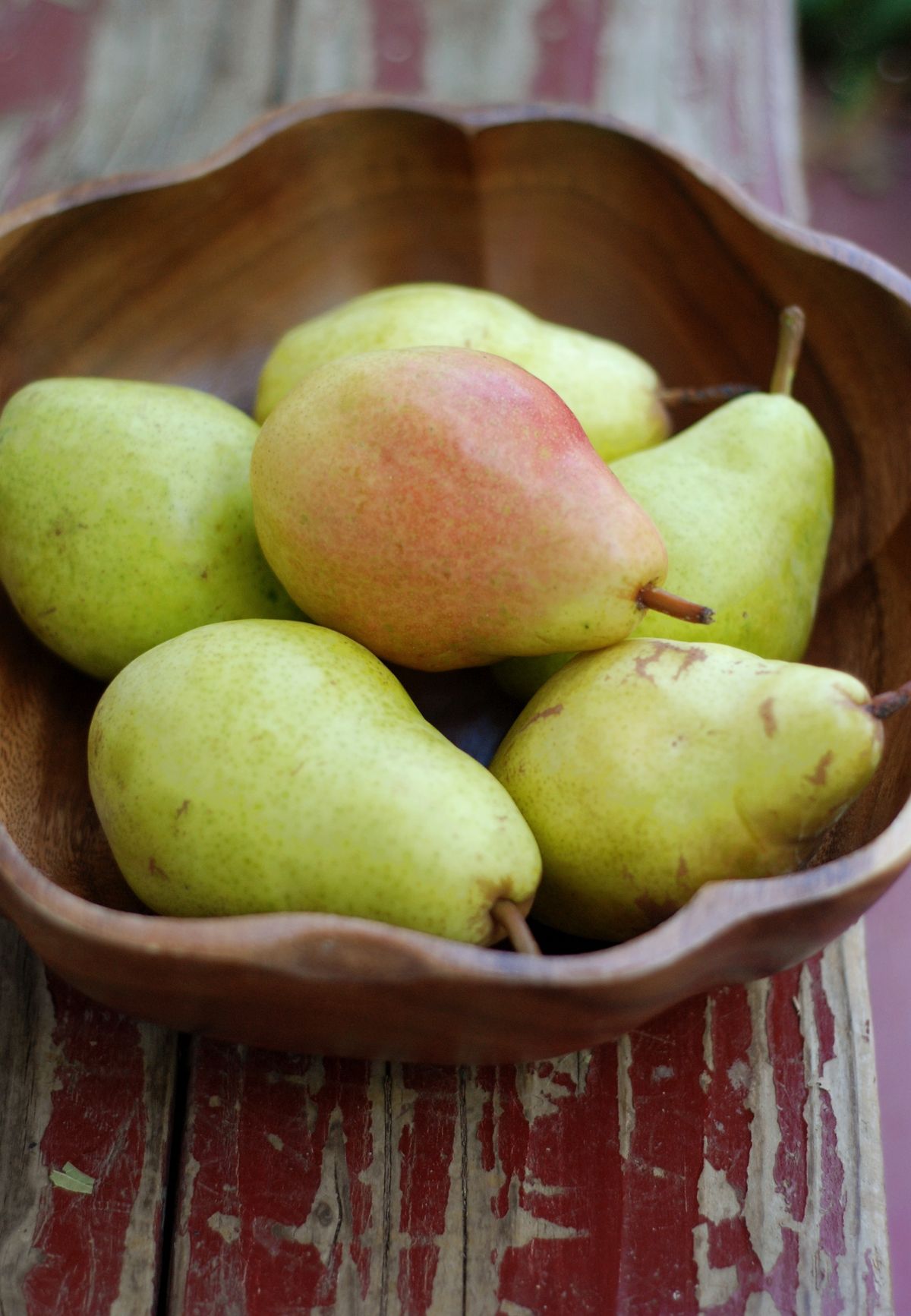 Rustic wooden bowl filled with fresh pears