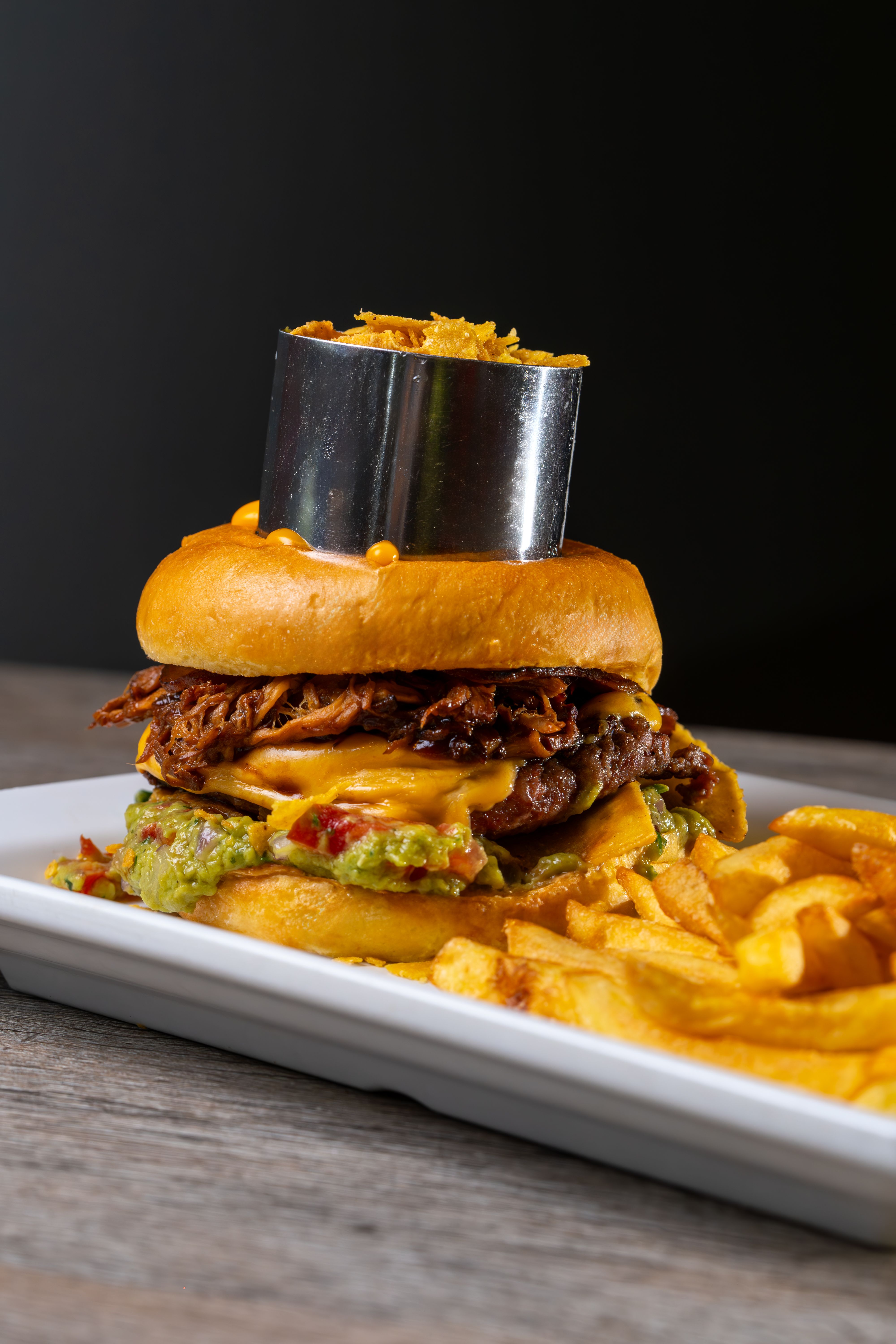Tasty cheeseburger with fries served on a plate, perfect for food lovers.
