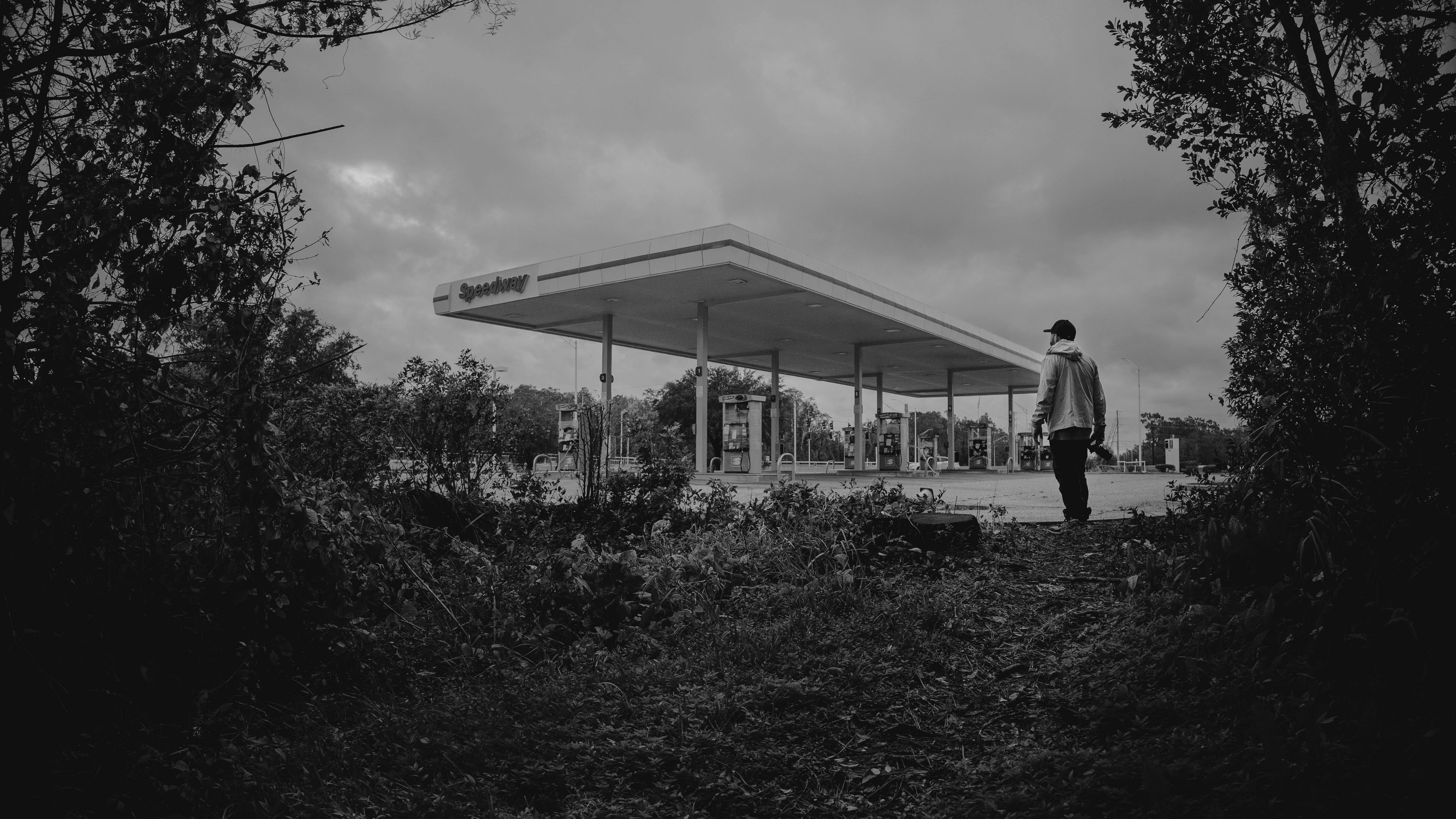 black and white gas station with lone figure