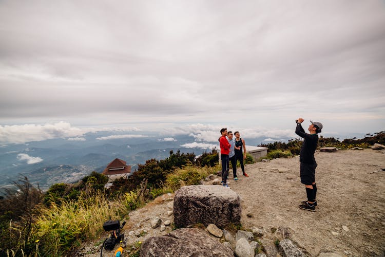 People Taking Photographs On A Plateau