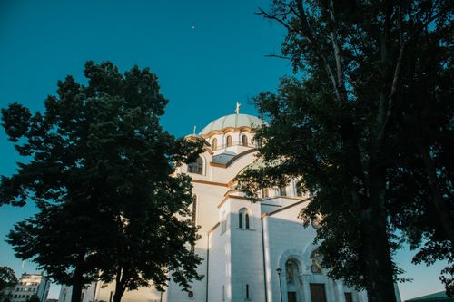 Free Stunning view of the Saint Sava Church surrounded by trees under a clear blue sky. Stock Photo