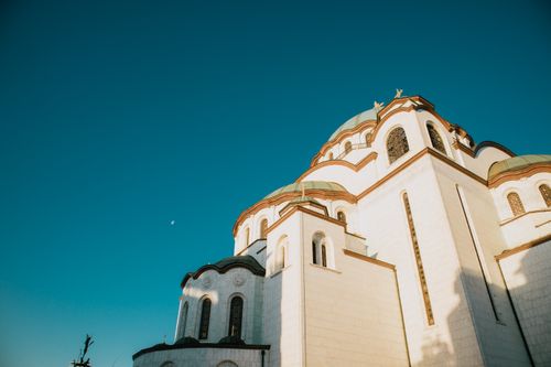 Free Beautiful view of a historic church with domed roof against a clear blue sky. Stock Photo
