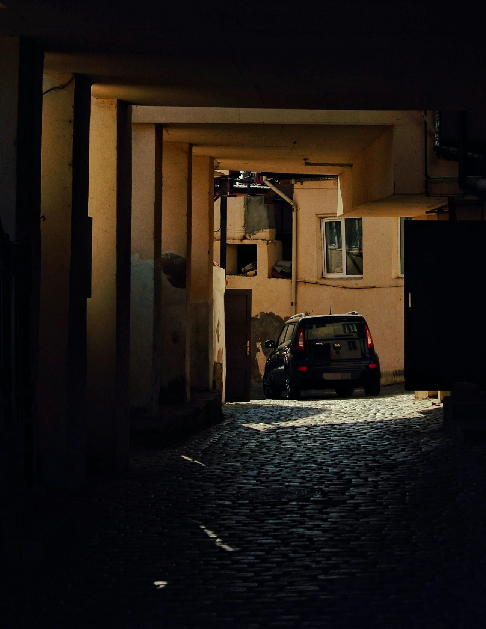 urban alleyway with car at twilight