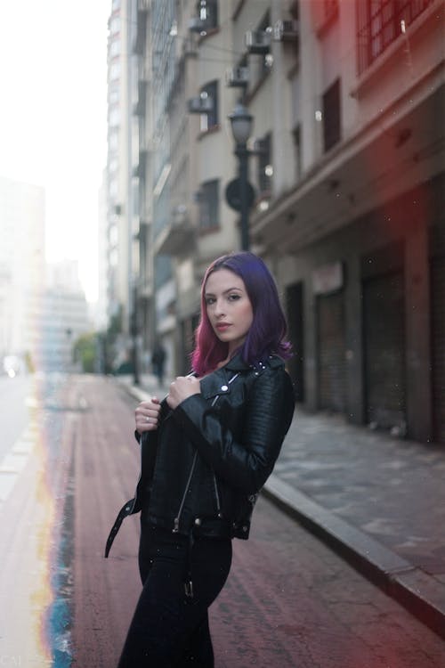 A Woman Wearing Leather Jacket Standing On The Street