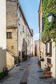 Explore a quaint cobblestone street in Antibes, showcasing historic architecture.