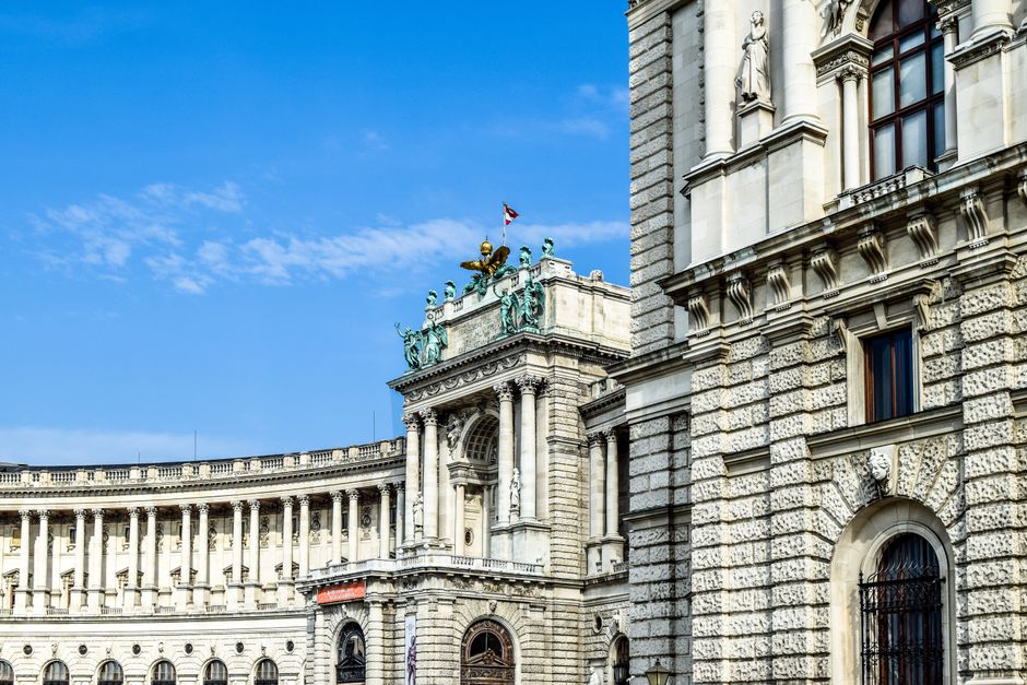 Stunning view of Vienna's Hofburg Palace exterior, showcasing its architectural grandeur against a clear blue sky.