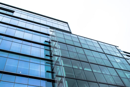 Low angle view of a modern glass facade building in Halifax, showcasing sleek architecture.