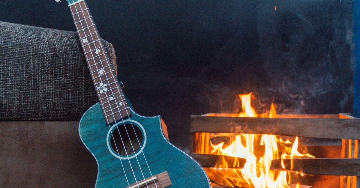 Stylish Ukulele by Cozy Indoor Fireplace · Free Stock Photo