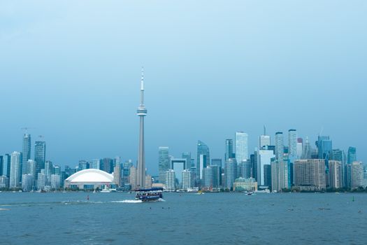 Breathtaking view of Toronto's skyline featuring CN Tower and Lake Ontario under a clear sky.