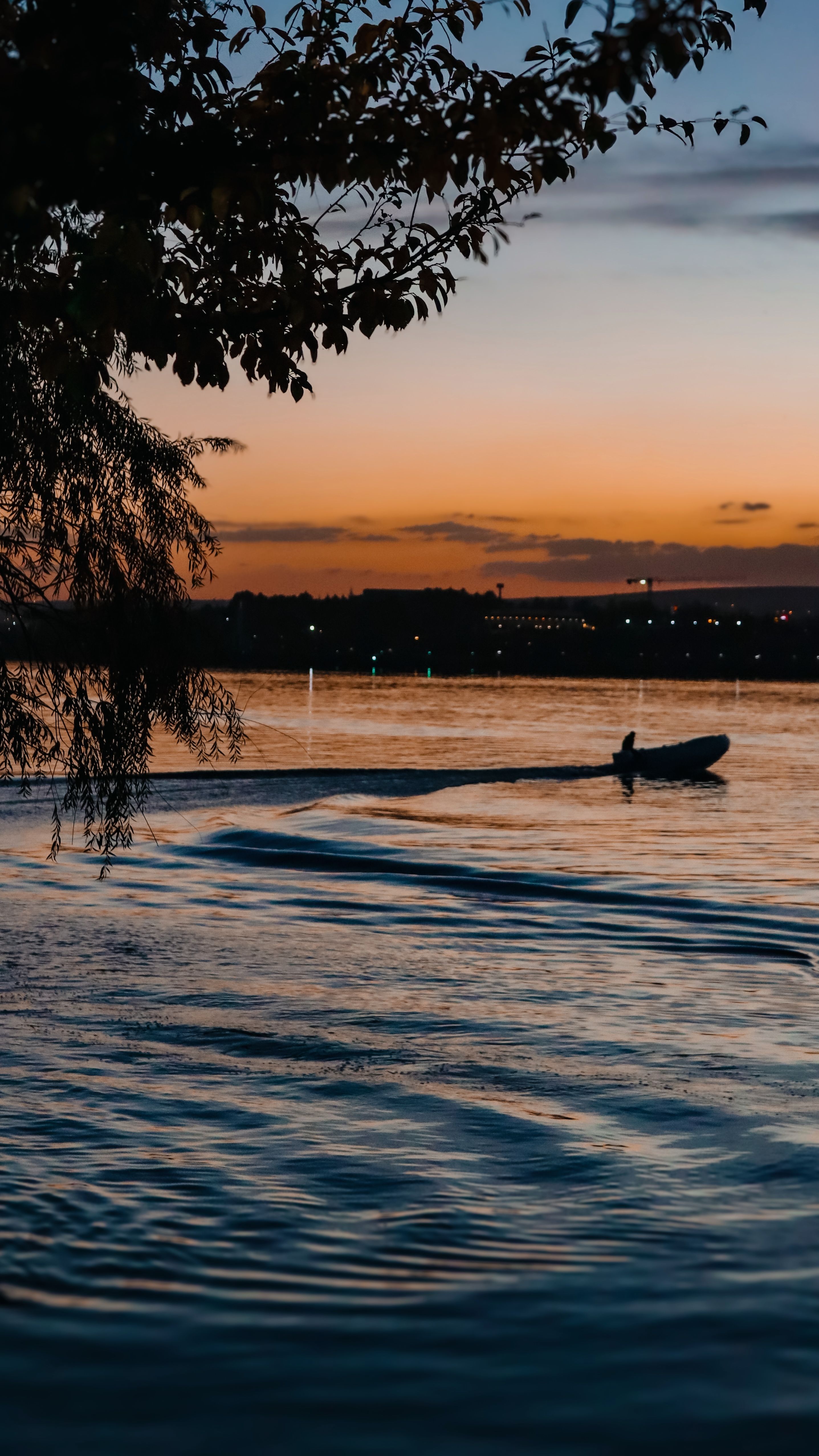 Sunset Silhouette of Boat on Tranquil Lake · Free Stock Photo