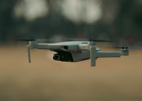 A drone flying close to the ground, ready to capture stunning aerial views outdoors.
