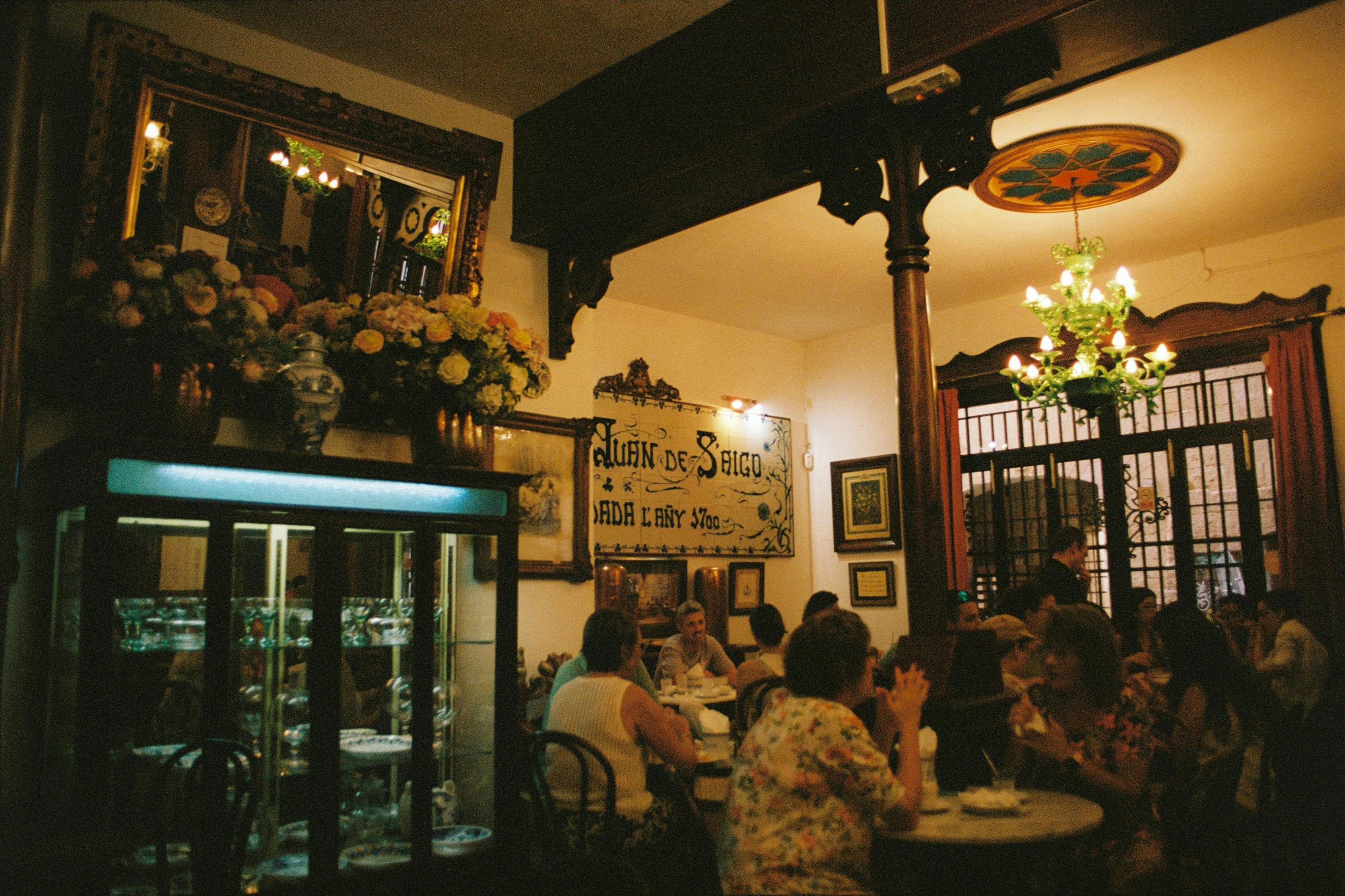 Free Inviting café setting in Palma captures vintage charm and lively social gathering. Stock Photo