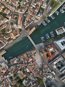 Aerial perspective of Zurich's Old Town and Limmat River with bridge crossing.