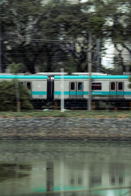 Free A fast-moving train reflected in water, highlighting speed and modern travel. Stock Photo