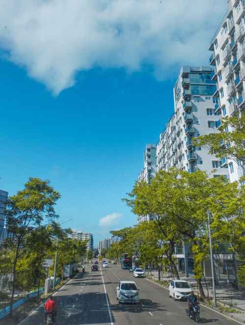Free Vibrant city street scene featuring modern high-rise buildings on a clear day. Stock Photo