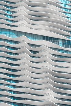 Close-up of Aqua Tower's unique wavy architectural design in daylight.