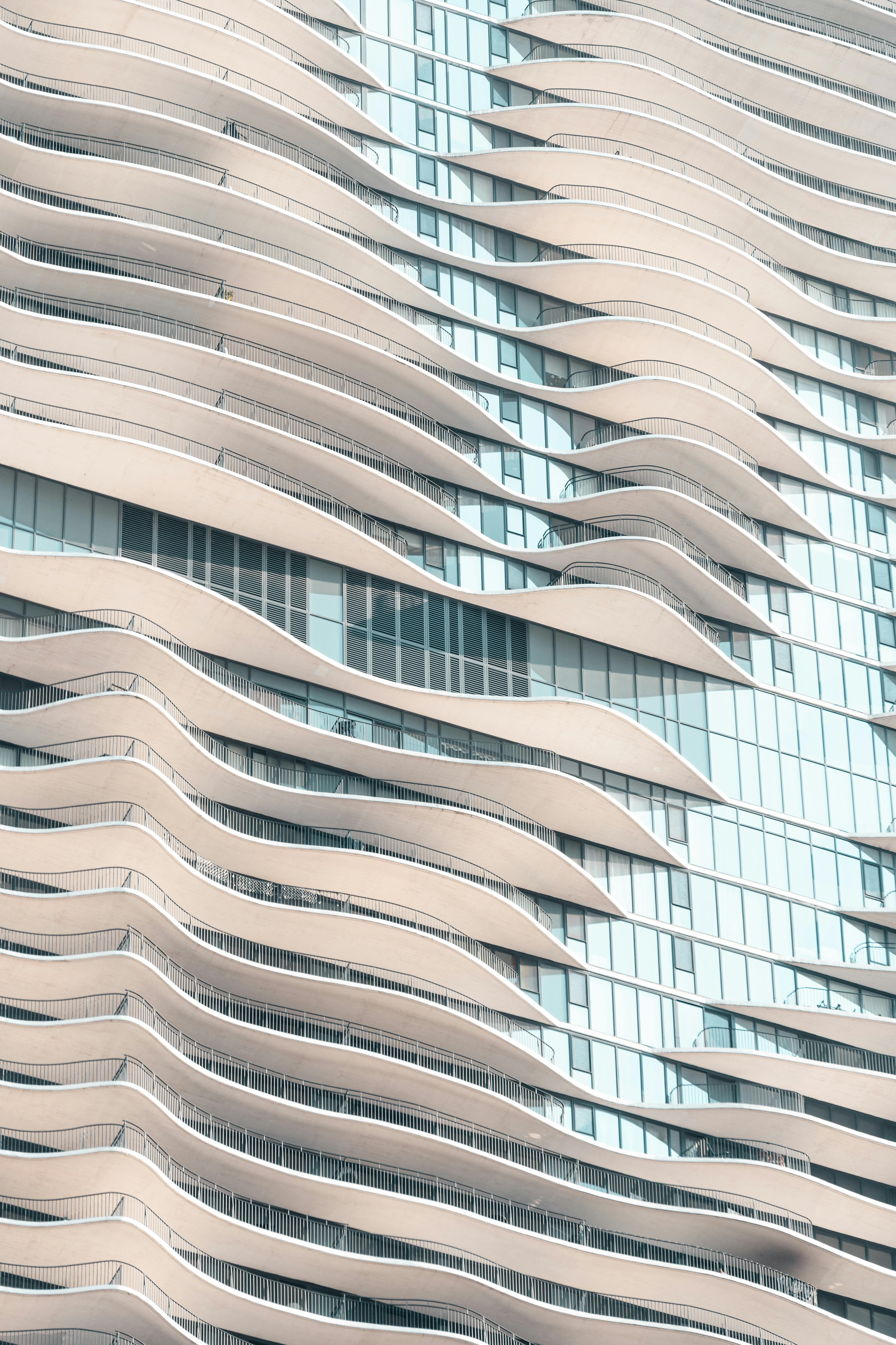 Close-up of a modern building with wave-like balconies.