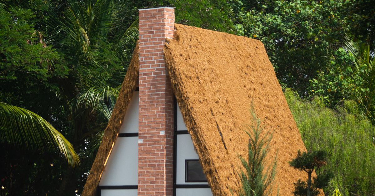 Thatched A Frame Charming A-Frame House with Thatched Roof in Forest · Free Stock Photo