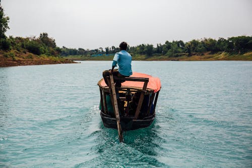 Photo Of Man On His Boat During Daytime