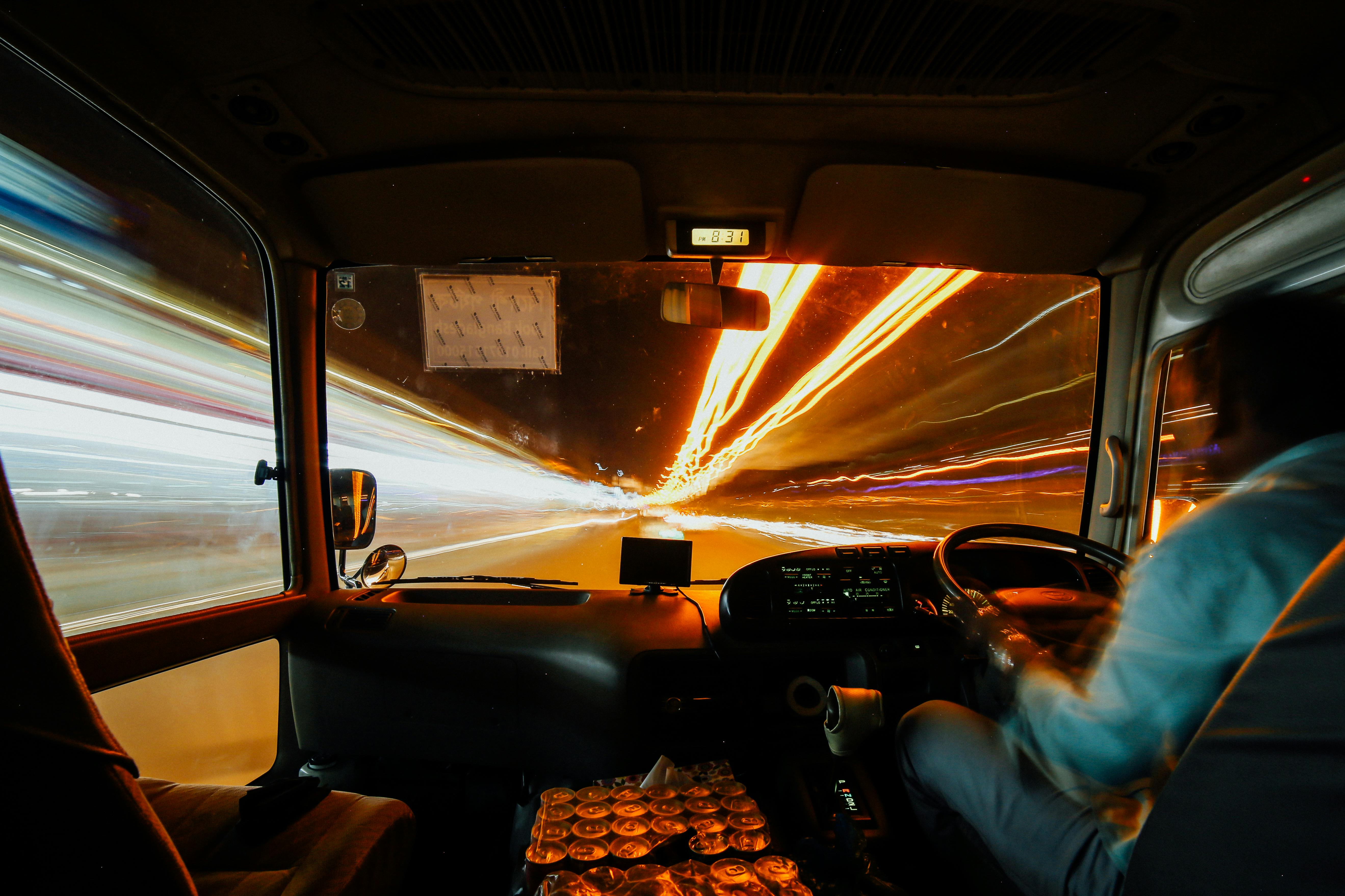 panning photo of man riding vehicle