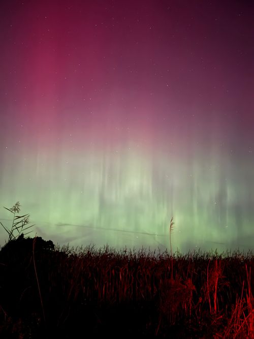 Aurora borealis over a dark horizon — photo by Humam Musawwir on Pexels
