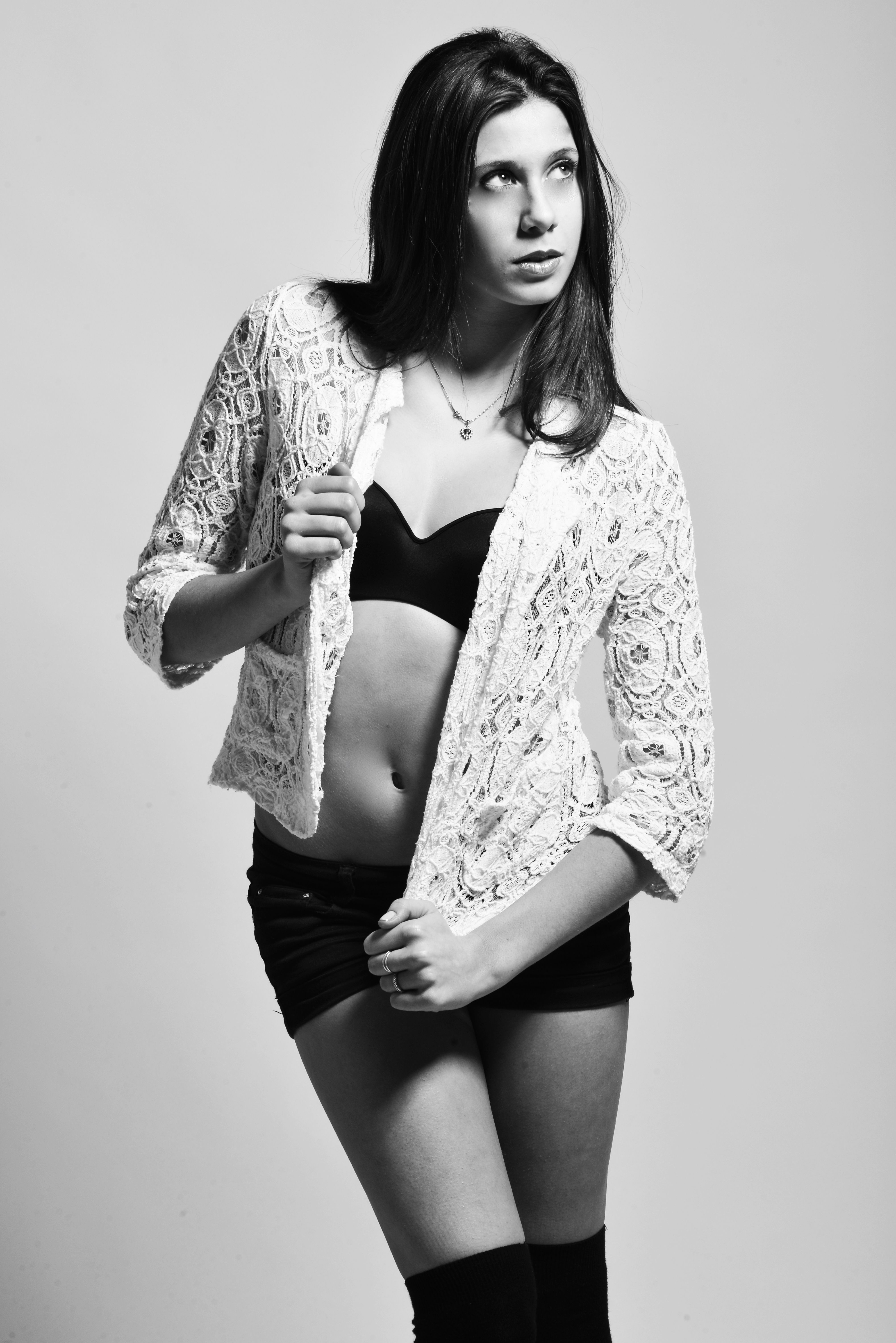 Elegant black and white portrait of a young woman in modern fashion attire.