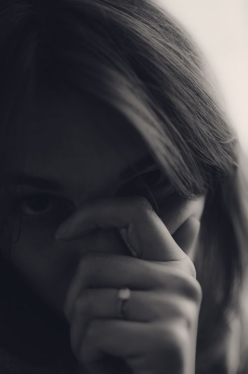 Free Black and white portrait of a woman in a thoughtful, contemplative pose. Stock Photo