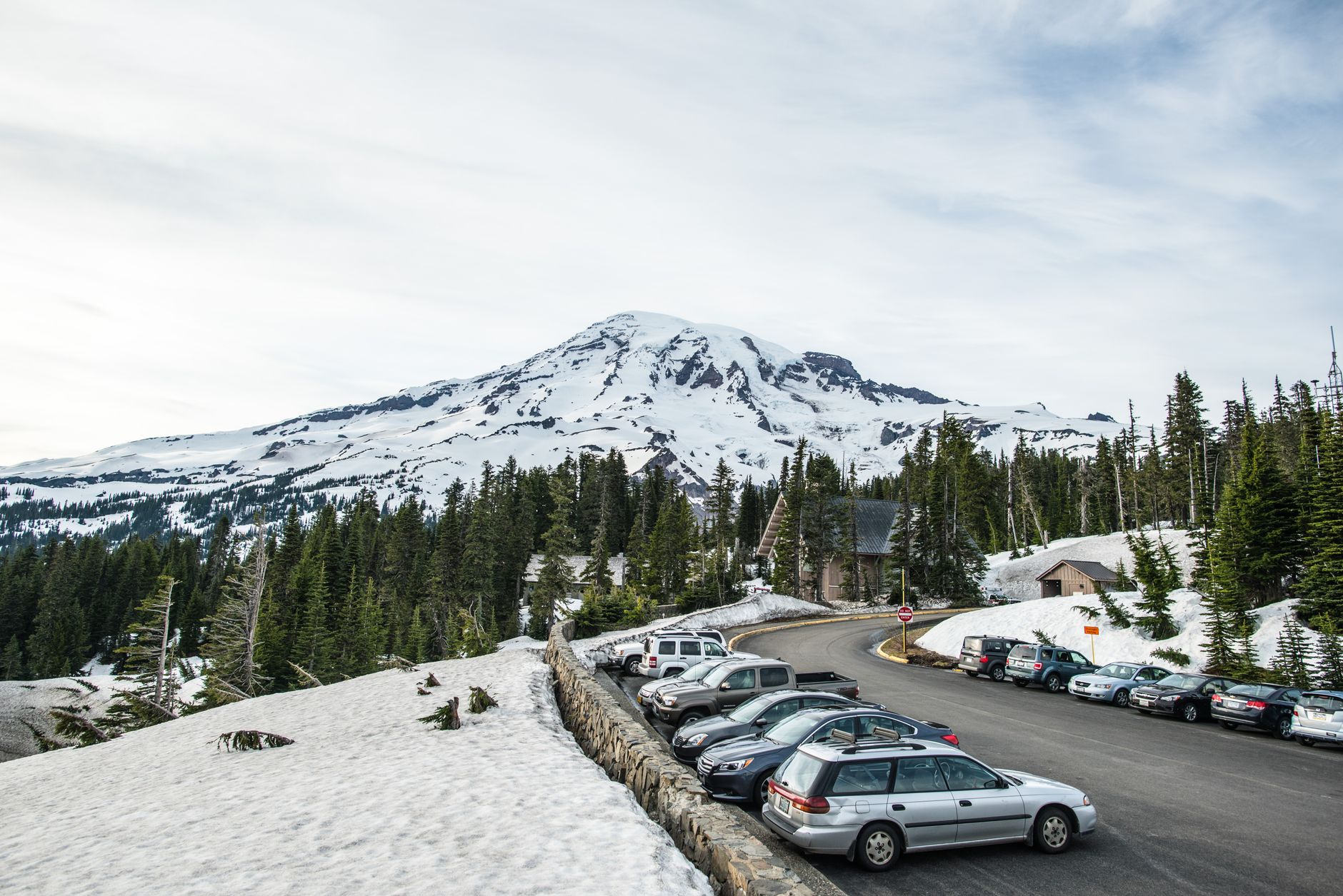 Scenic view of a snowy mountain landscape with parked cars. โ photo by dumitru B / Pexels