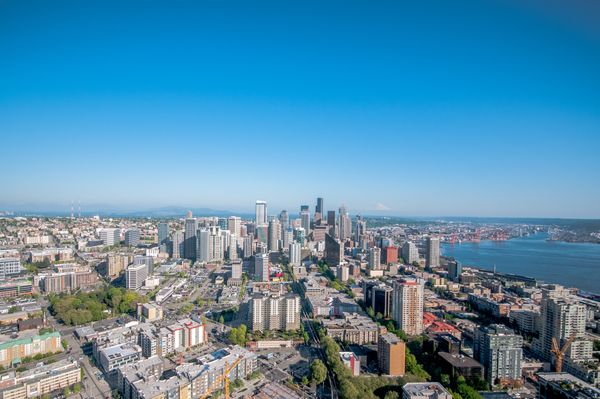Aerial view of the Seattle skyline and Elliott Bay on a clear day, the city side of the Seattle vs. Bellevue choice