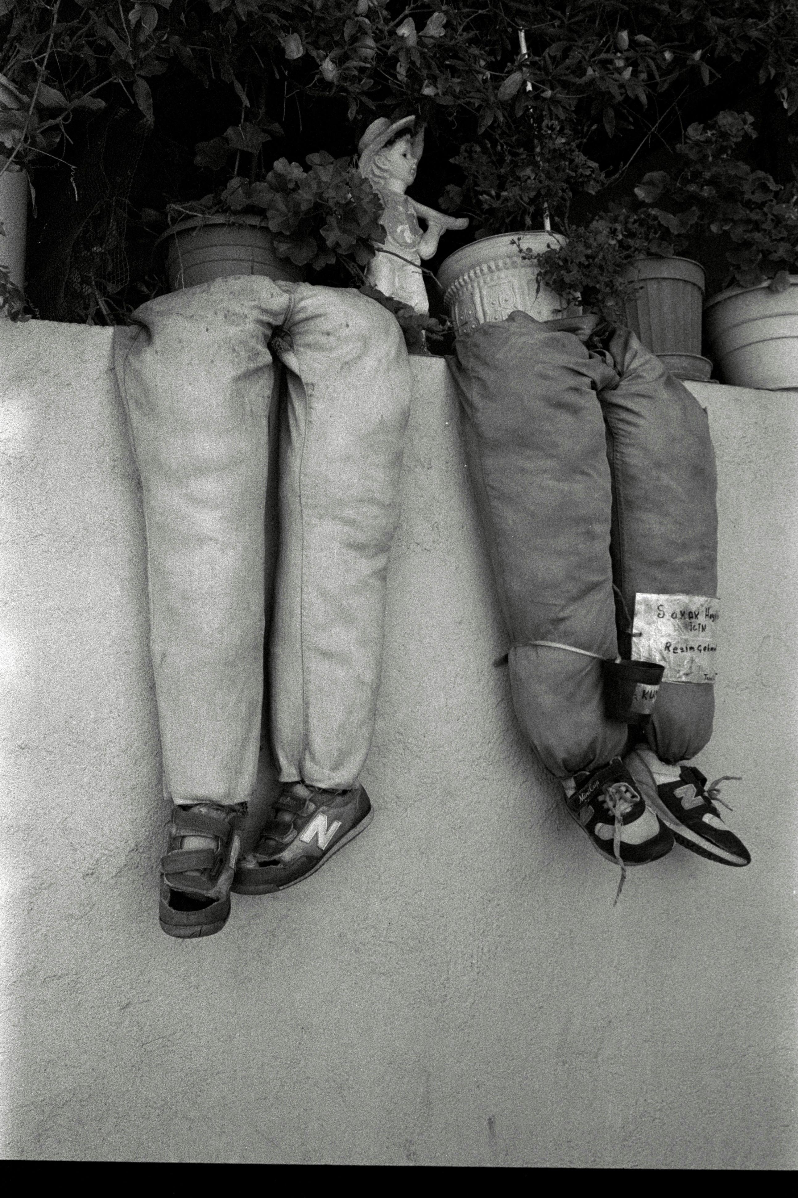 Unique black and white street art featuring planted pants in Amasya, Türkiye.
