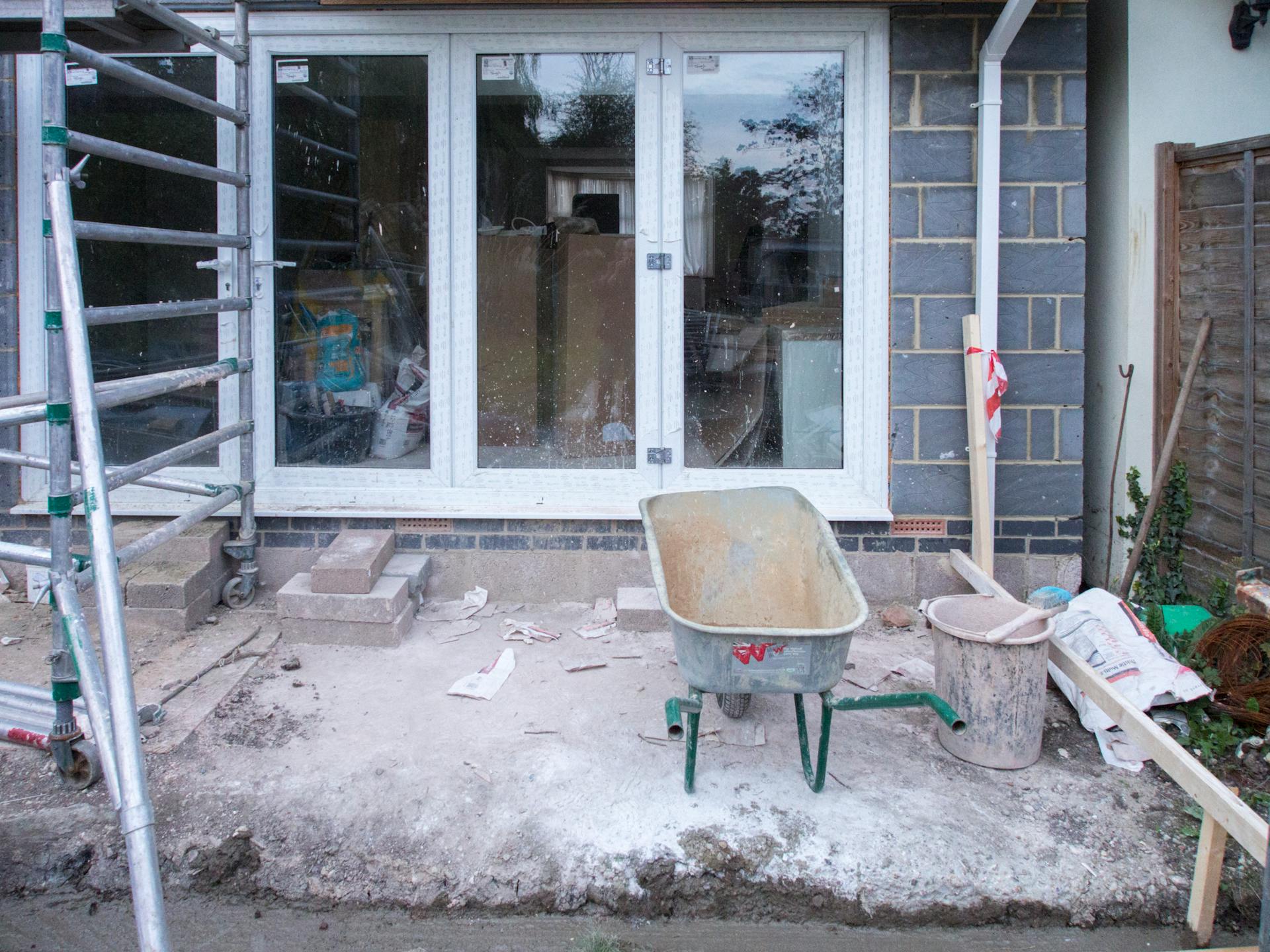 A construction site showcasing home renovation with scaffolding and tools.