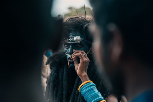 Free Intricate face paint and costume at a vibrant Indian festival celebration. Stock Photo