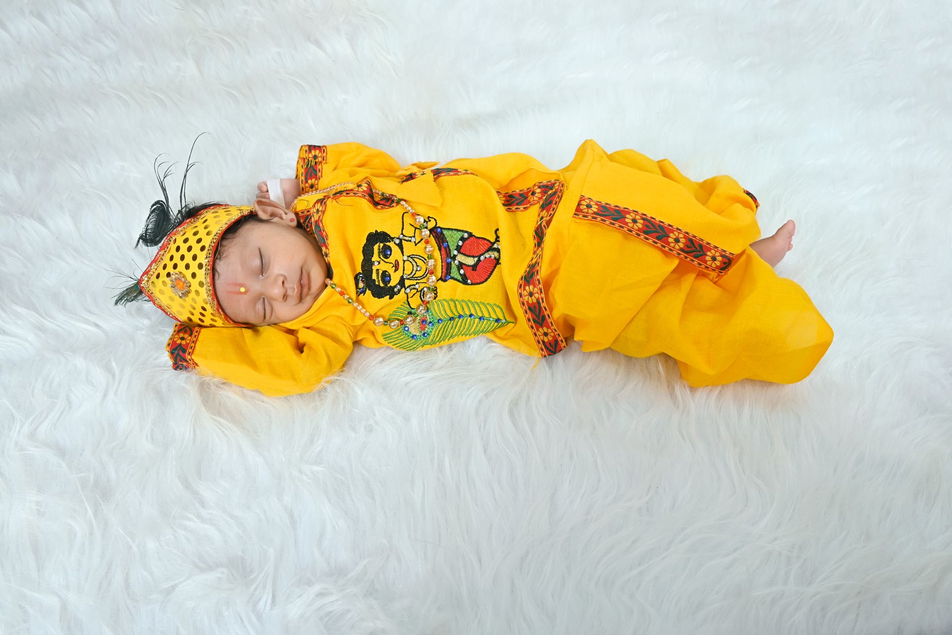 A kid dressed up as Lord Krishna