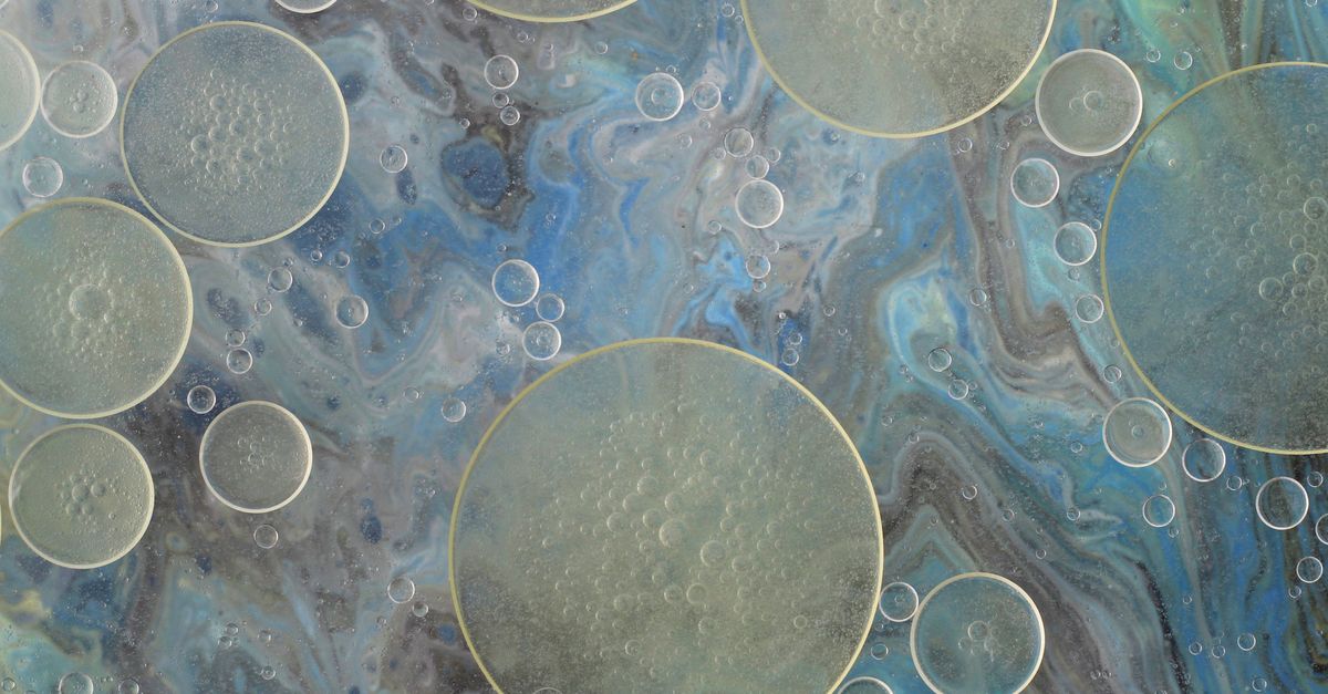 Close-up of transparent bubbles over a swirling blue and grey abstract background. - Evidence evidence guide for algae-oil-triglycerides-meta-analysis