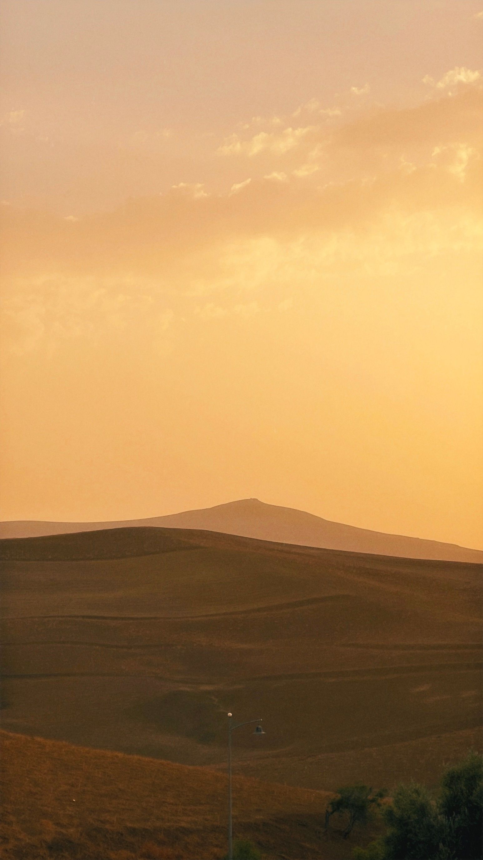 Serene Sunset Over Rolling Hills Landscape · Free Stock Photo