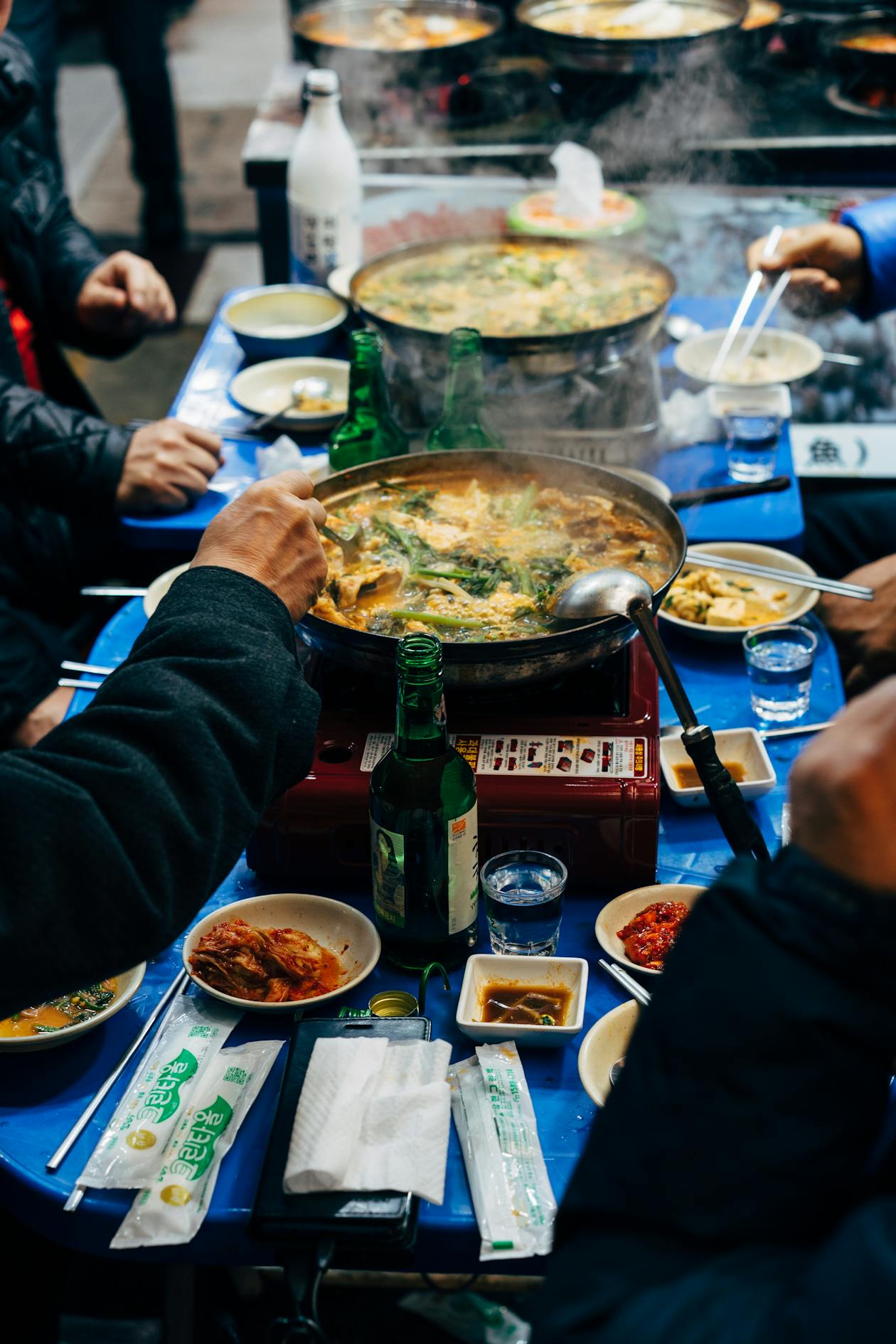 Busy Korean traditional market with street food stalls and local shoppers