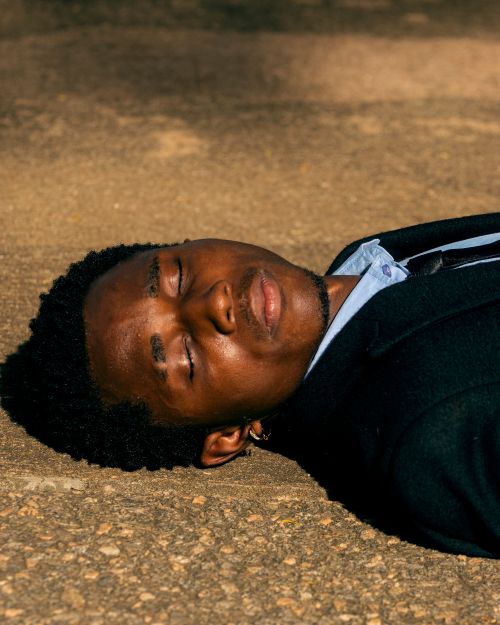 Free Close-up portrait of a man resting outdoors on a sunny day. Stock Photo