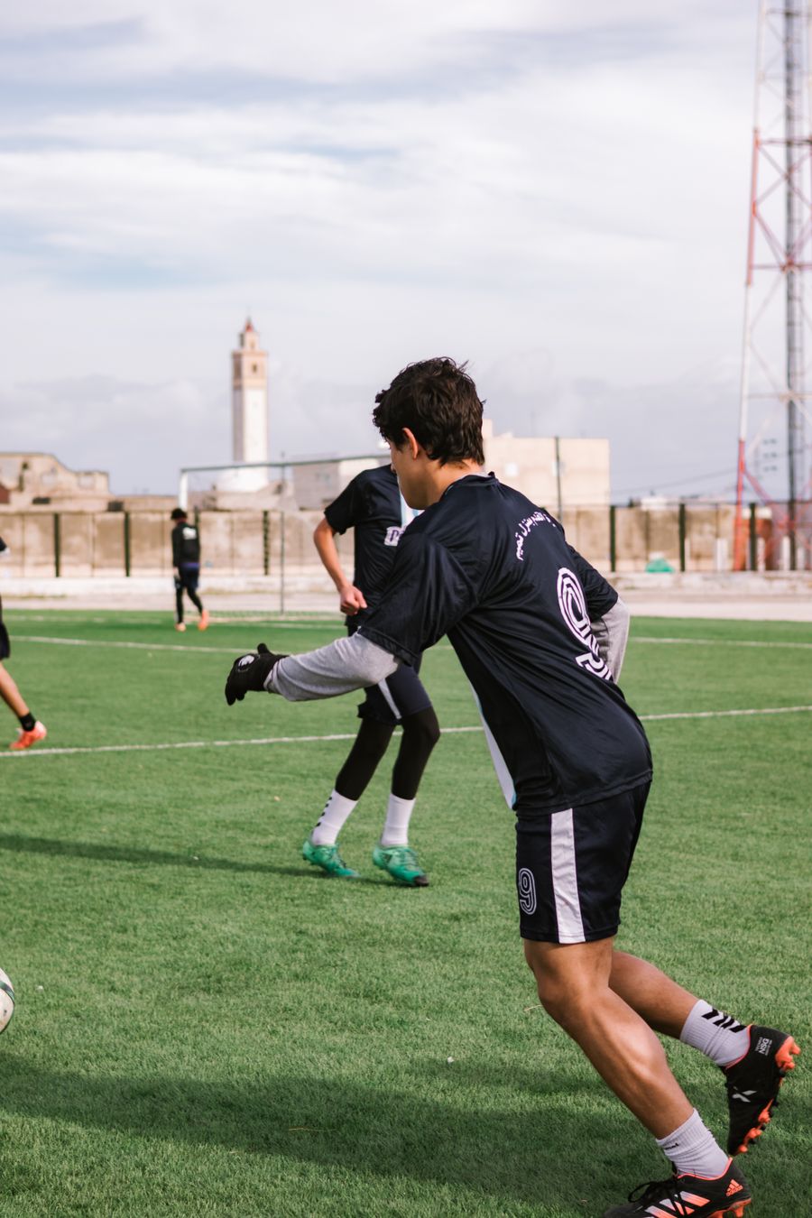 Teen soccer players practicing on a field