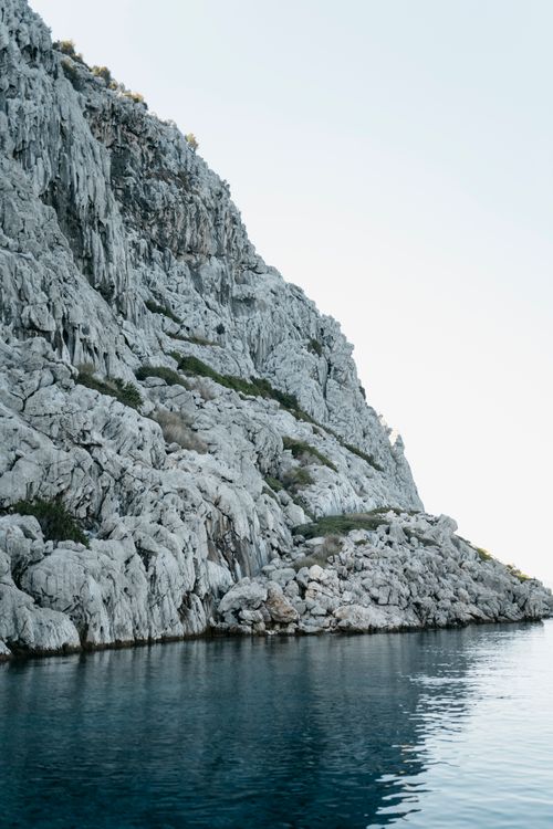 Free Calm and serene rocky coastline in Selimiye, Türkiye with a tranquil sea view. Stock Photo