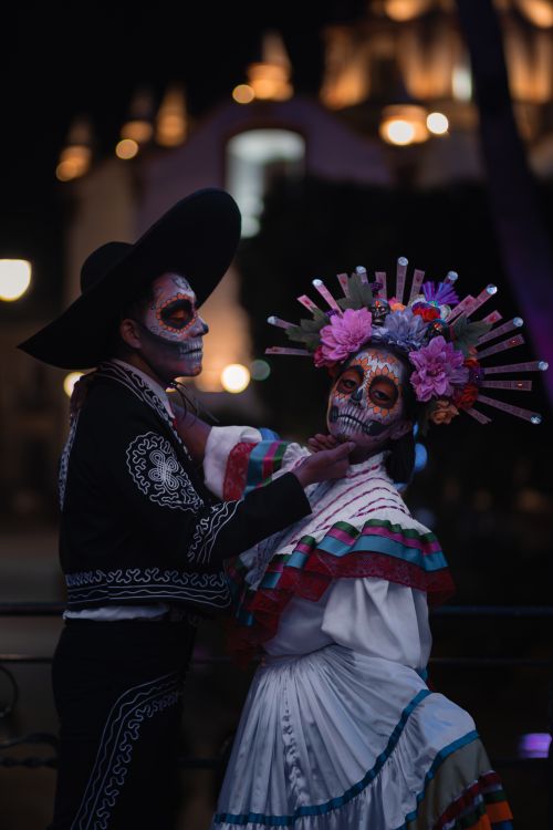 Free Couple in traditional Dia de los Muertos attire and makeup in Puebla, Mexico at night. Stock Photo