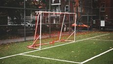 Soccer field with goalpost in Montreal neighborhood during fall season.